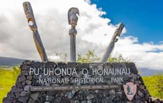 Entrance sign of Pu'uhonua O Honaunau National Historical Park on a Kona cruise ship tour.