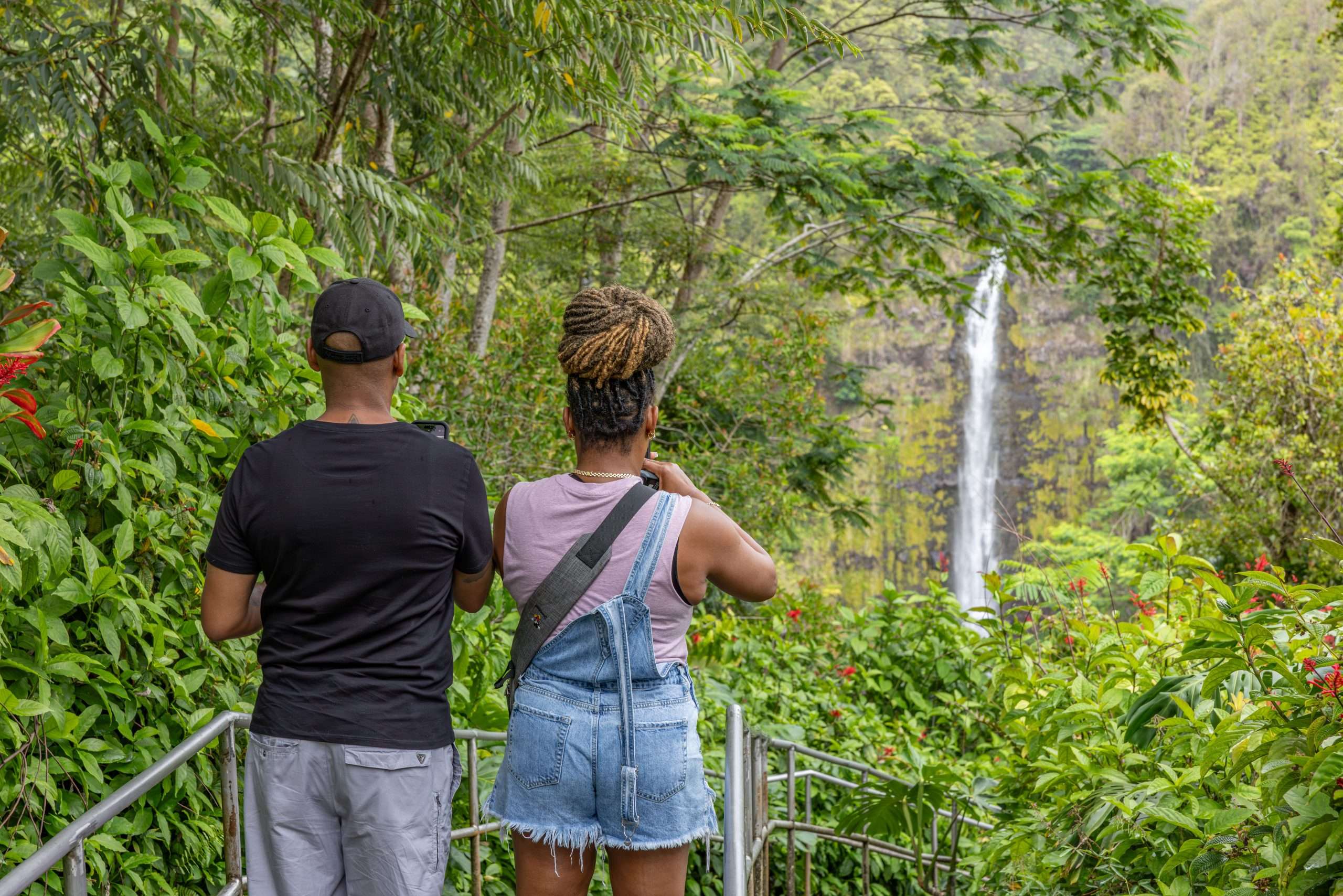 Big Island grand circle tour guests taking photos of Akaka Falls.