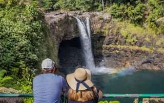 Big Island tour guests at Rainbow Falls Hawaii.